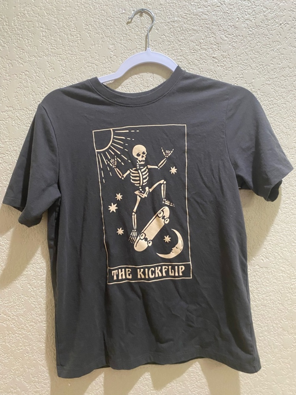 wonder nation Black Tee with Cream Skeleton Skateboard Graphic